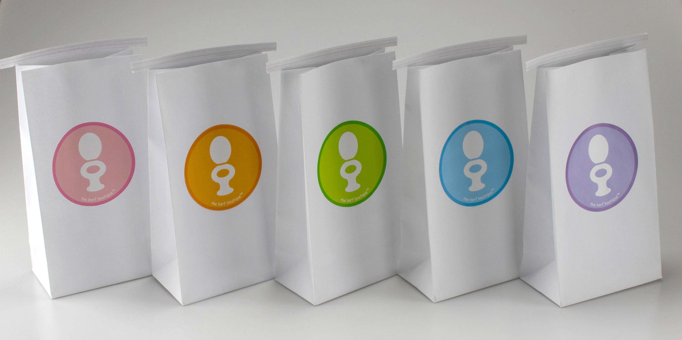 five white barf bags with colorful toilet logos by the barf boutique